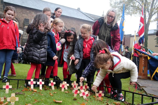 Children plant there crosses in the garden of remembrance. 