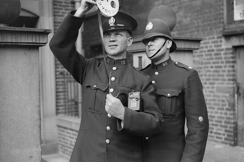 Chesterfield police photographer PC Sanders shows some film to his assistant Police Constable Wheatcroft pn 25th July 1935:
