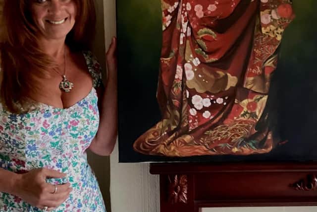 Sue Dickins, alongside her Broken Hearted painting.
