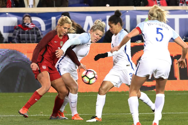 United States' Allie Long (L) battles with Bright and Demi Stokes for the ball as the United States and England women's national teams play in the SheBelieves Cup in Harrison, New Jersey, in 2017.
