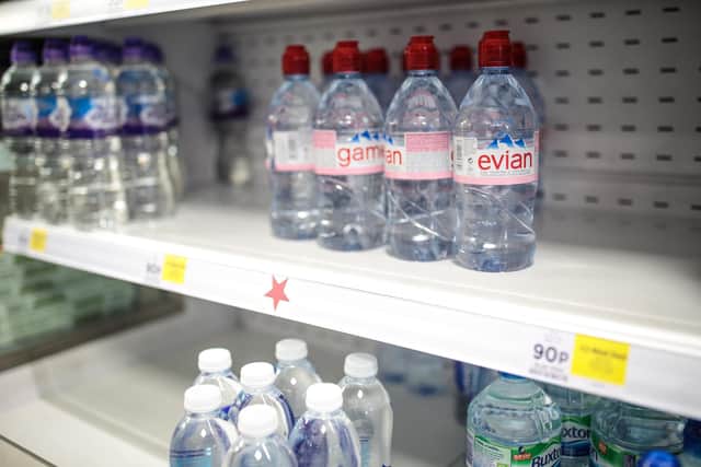 Plastic water bottles on display in a supermarket. Photo by Jack Taylor/Getty Images.