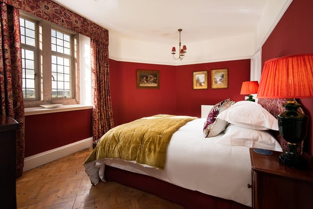 The listing says the master bedroom is 'resplendent in deep Farrow & Ball crimson and feels suitably regal'.

Picture: T Bloxham Inside Story Photography