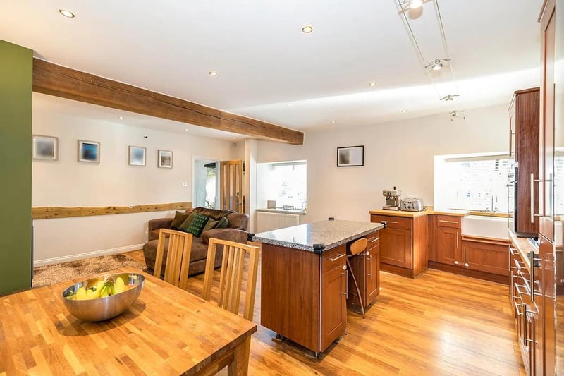 The kitchen area also benefits from a central island with base units, breakfast bar and granite worktop.