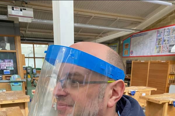 A member of staff from Dronfield school tests a visor.
