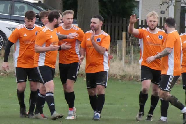 Aidan Ordidge (third from left) is congratulated after scoring for Mutton. Photo: Martin Roberts