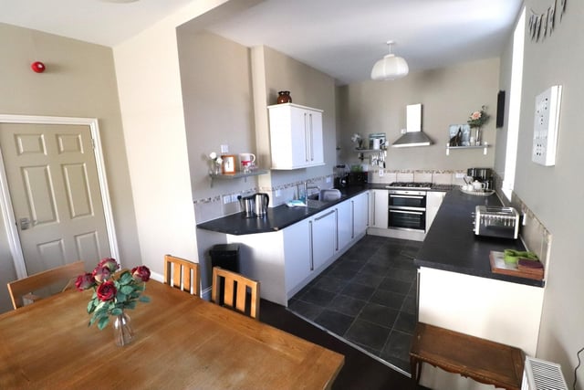 The well equipped kitchen has modern white wall and base units with roll edge worktops. Integrated appliances include oven with grill, hob and extractor over, dishwasher, fridge freezer and washing machine.