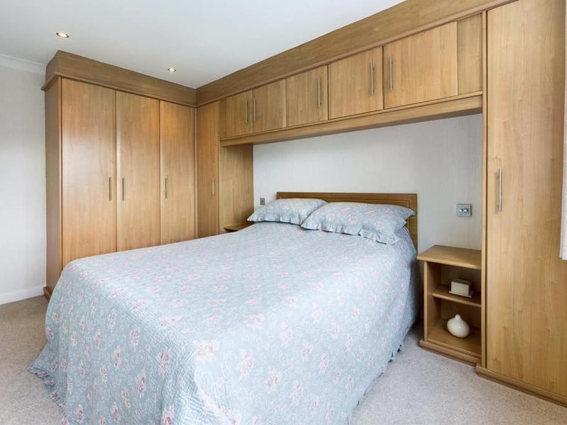 Master bedroom - uPVC double glazed window to the front elevation, fitted wardrobes and a range of fitted cupboards to one wall, ceiling coving, radiator panel and power points.