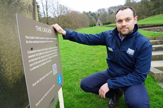Rob Harrison, head of operations, beside a sign that sets out the restoration project and how much it will cost.