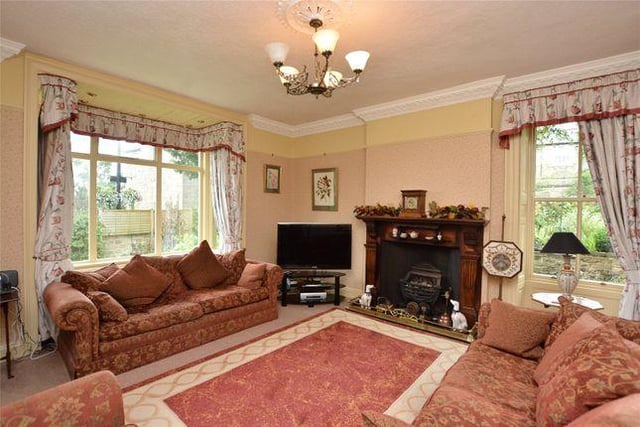 The property features a bright, airy living room and a sitting room