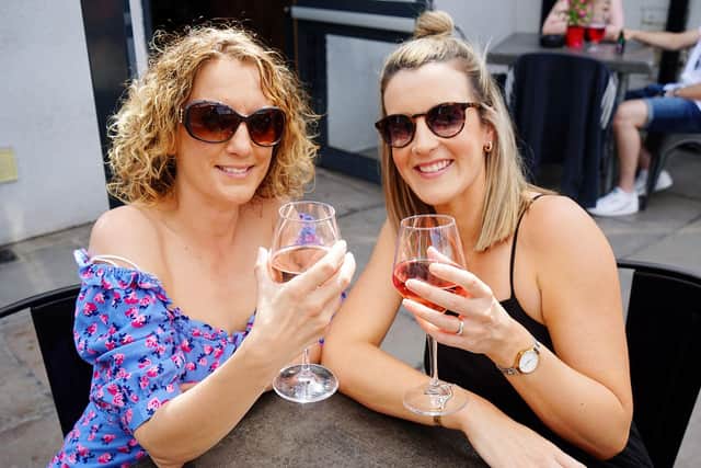 Jemimah Vine and Emily Millan enjoy the sun at the Junction Bar in Chesterfield last week, with warm weather set to continue