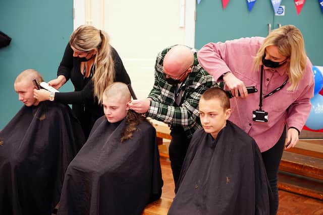 Pupils Jake Ford, Finley Moore and Asa Hopkins go first for the headshave from Rock Paper scissor staff, Lauren Turner, Leslie Dillingham and Emma Hodgkiss.