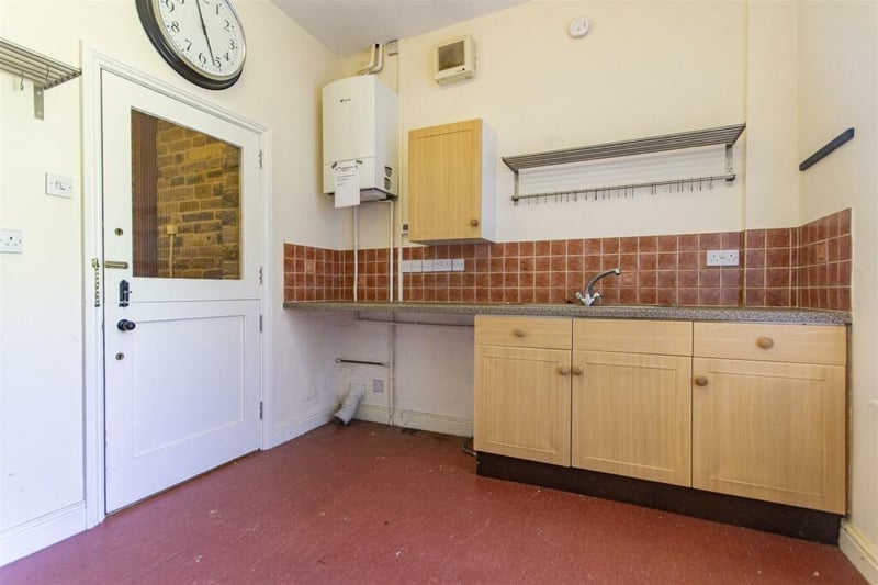 The utility room, off the kitchen, has beech effect units and an inset sink. There is space for  a washing machine and space and vent for a tumble dryer.