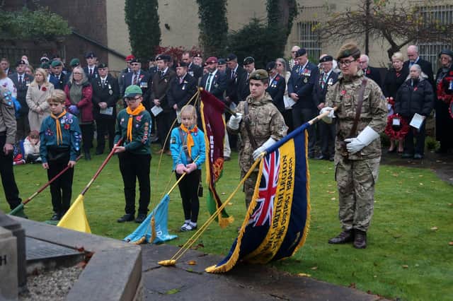 Standards are lowered for the last post by scouts, cubs, brownies and army cadets.