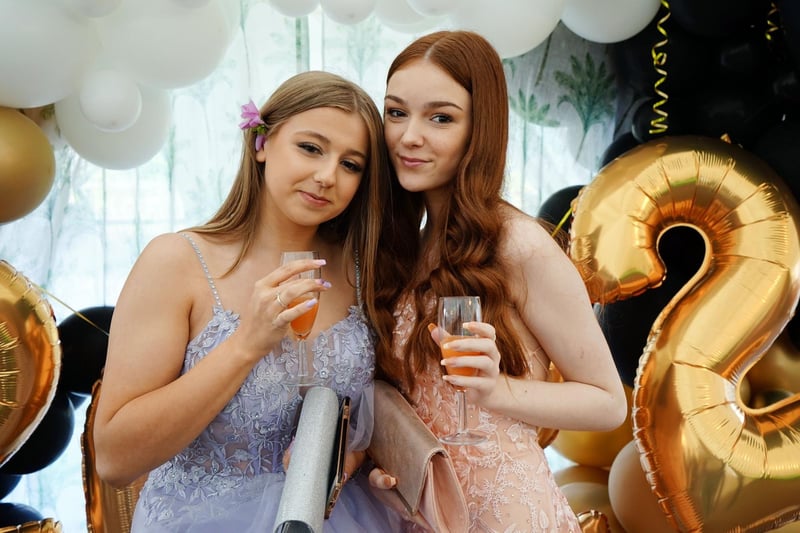 Brooke Boulton and Erica Haywood enjoy a drink at Brookfield Community School during a prom night.