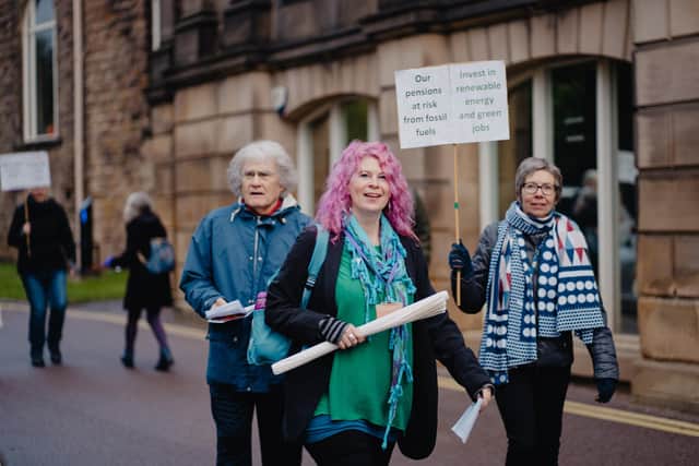 Placards being waved outside County Hall. Photo: Maddy Winters