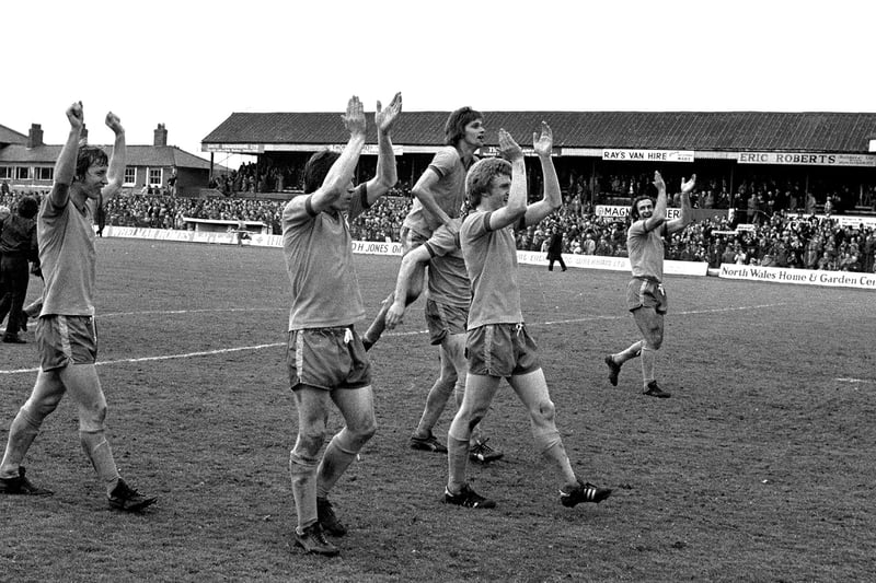 Stags celebrate promotion after last game win at Wrexham's Racecourse Ground.
