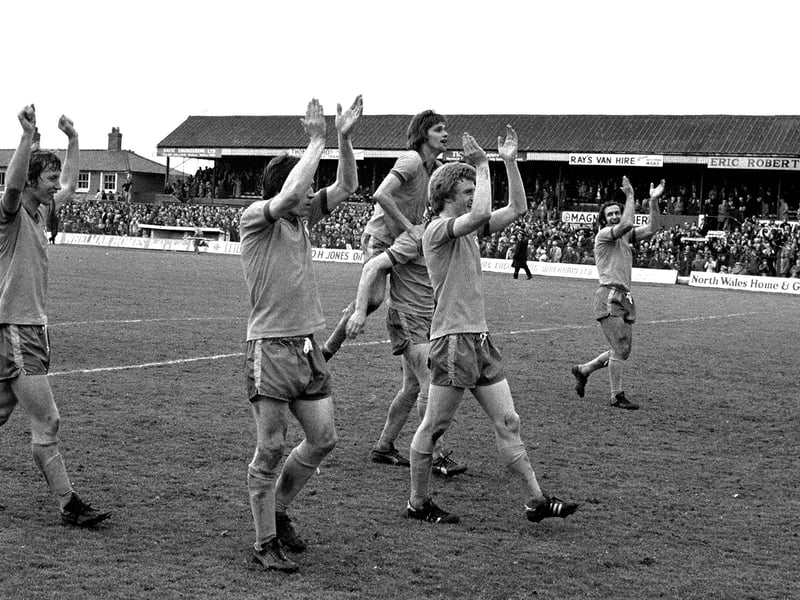 Stags celebrate promotion after last game win at Wrexham's Racecourse Ground.