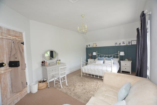 This bedroom radiates elegance and boasts plenty of space. You can even relax on the sofa.