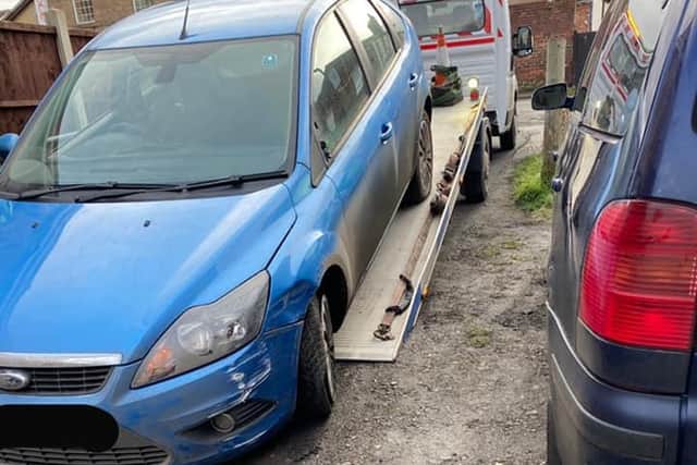 The Ford Focus was seized by police after the motorist was said to be driving erratically and knocking over wheelie bins.