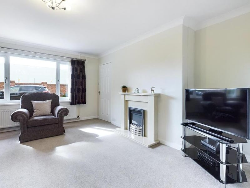 Lounge/dining room - Double aspect room with uPVC double glazed window to the front elevation, feature fireplace with inset and raised hearth incorporating electric fire unit, uPVC double glazed window to the rear elevation, two radiator panels and power points.