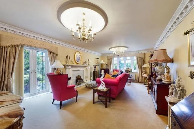 This luxurious  lounge with ornate coving has doors leading out to the rear garden.