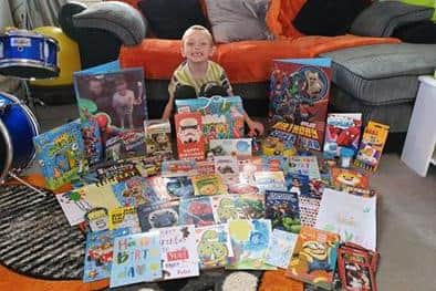 Five-year-old Rylee Mulvey with all the birthday cards and presents given to him by the community to cheer him up