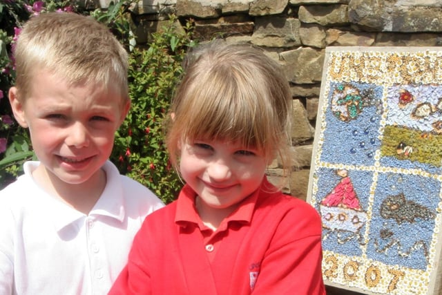 Nathan Mather and Millie Wykes, pupils at St Mary's Primary School, Unstone, with their school's well dressing.