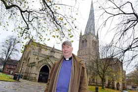 Reverend Patrick Coleman outside Chesterfield's Crooked Spire church which has received a funding boost to carry out roof repairs. Picture by Brian Eyre.