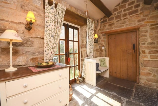 Exposed stone work, wooden panelled doors with thumb-nail latches and the stone-flag flooring highlight the cottage's charm.