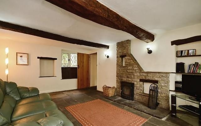 Exposed stonework and ceiling beams plus stripped wooden door reflect the olde-worlde charm of the main house.