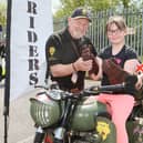 Brian Lewis of the Royal British Legion Riders shows off his bike to Ava and Callum Trustwell.