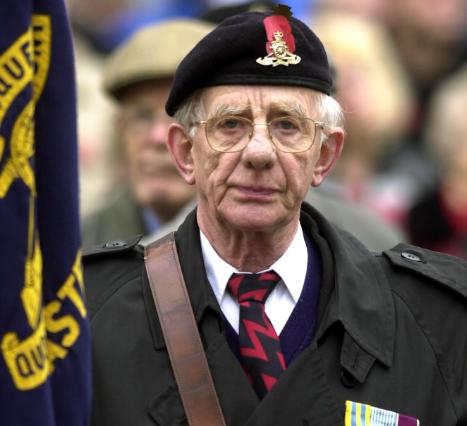 A gentleman walking in the Remembrance Parade in 2002.