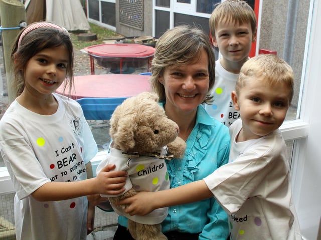 Millie Hardy, Sue Beckett Head Teacher, Jack Wright and McKenzie Marples are pictured at Christchurch School after 100 Children in Need T shirts were donated in 2011