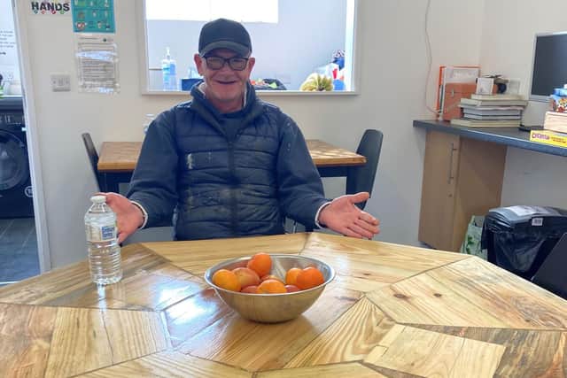Wayne Rodgers sitting at a table he has made through attending Growing Lives