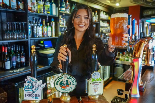 Manager Eloise Bestwick with  a pint of Timothy Taylor, one of the many beers on offer at the Mow.