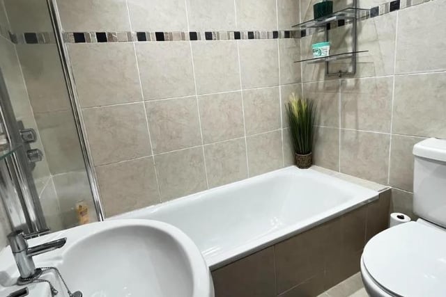 The well appointed bathroom is fully tiled and contains a bath with shower over, wash basin and wc.