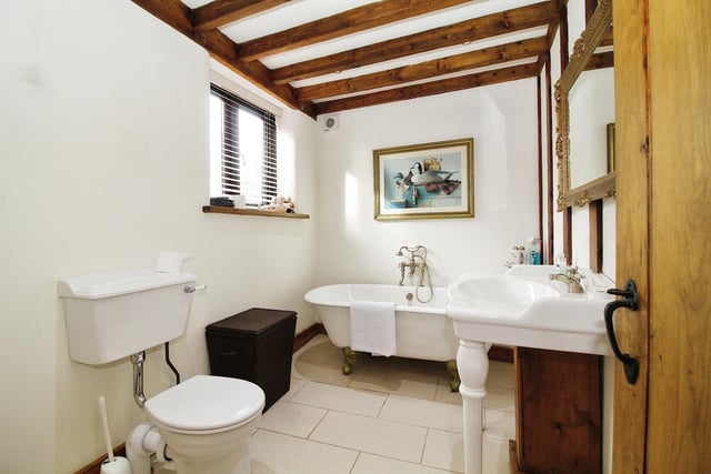 Completing our look at the second floor is this charming family bathroom. It consists of a roll-top, claw-foot bath with mixer tap and shower attachment, vanity wash hand basin, high-flush WC and the obligatory beamed ceiling.