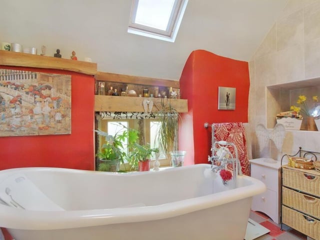 The cast iron, claw foot slipper bath takes pride of place among a suite that included double length corner shower cubicle, wash basin and wc.
