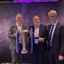 Jamie Hewitt and Mike Goodwin pictured with the award alongside Mick McCarthy.