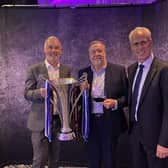 Jamie Hewitt and Mike Goodwin pictured with the award alongside Mick McCarthy.