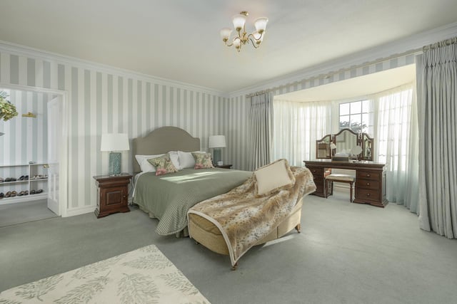 A large master bedroom with a walk in wardrobe, dressing room/office and spacious en suite.