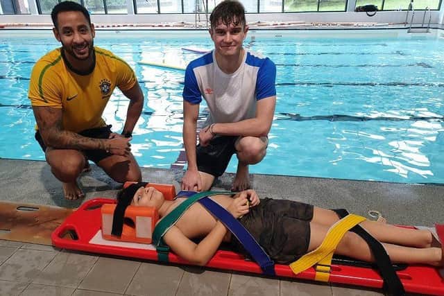 Pictured (from left): NEDDC lifeguards Daniel Clay and Joshua Ward, with ‘casualty’ Rhivan.