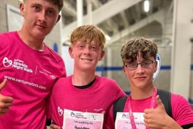 Beau (right),  Reuben (centre) and their friend were first to the finish line to set a new record for the fastest time. The boys took part in the Sparkle Night Walk  in memory of Beau's dad who passed away from cancer.