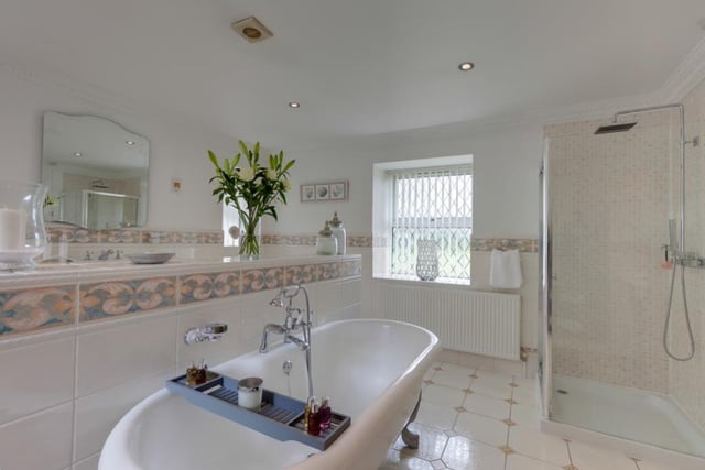 The Master En-Suite has both a standing bath and a shower, with the toilet and wash basin found behind the wall in the centre of the room with the bath.