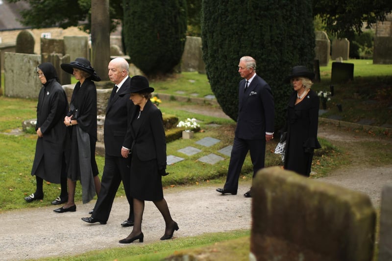 King Charles III, formerly The Prince of Wales and Queen Camilla follow the Duke and Duchess of Devonshire, Lady Sophia Cavendish and Lady Emma Cavendish during the funeral of Deborah, Dowager Duchess of Devonshire at St Peters Church, Edensor on October 2, 2014 in Chatsworth.