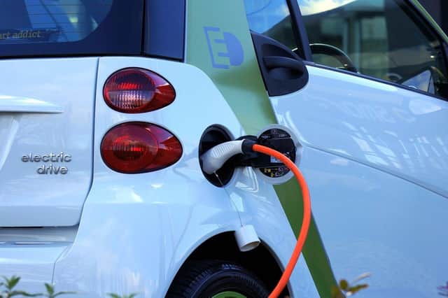 Electric car at charging point.  Photo by Pixabay