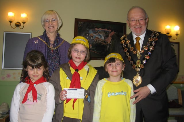 Staveley Brownies Georgina Millen, Becky Miles and Bridget Kaye are presented with a cheque by the Mayor and Mayoress of Chesterfield, Councillors Keith and Glenys Falconer, in 2006.
