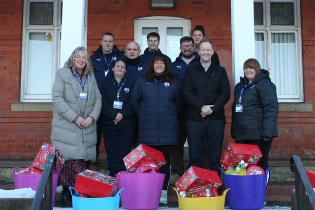 Members of the Hampers team in front of the Queen's Park pavilion. Left to right: Jayne Bacon (Chief Operating Officer, CFC Community Trust), Darren Parkinson (Business Development Manager, Community Trust), Esther Maxey (volunteer), Carl Cappellano (volunteer), Glyn Simmonds (Finance Officer, Community Trust), Becks White (Hamper Project Manager), Keith Jackson (Deputy Chief Operating Officer, Community Trust), Faith Conder (volunteer), Nigel Mallender (Cricket Club chairman) and Andrea Parkinson (Wellbeing Manager, Community Trust)