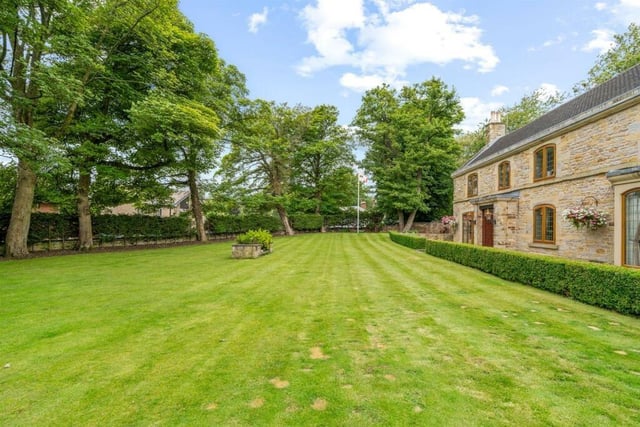 The property is set in half an acre of grounds with a large lawn at the front of the house.
