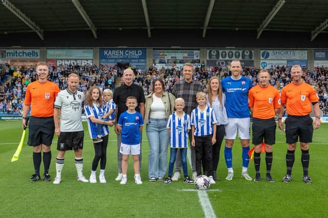 Drew Talbot and his family on the pitch before kick-off. Picture: Tina Jenner.